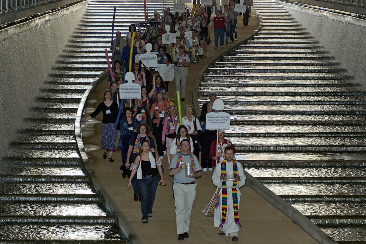 Members of Methodist Students for an All-Inclusive Church (MOSAIC) march to the Allegheny River through the David L. Lawrence Convention Centerin Pittsburgh, site of the 2004 United Methodist General Conference. The group is pushing the denomination to fully accept gays and lesbians in its churches and pulpits. At the end of the march it held a service of renewing the baptismal covenant on the banks of the Allegheny River. A UMNS photo by Paul Jeffrey. Photo number GC04324, 5/01/04
