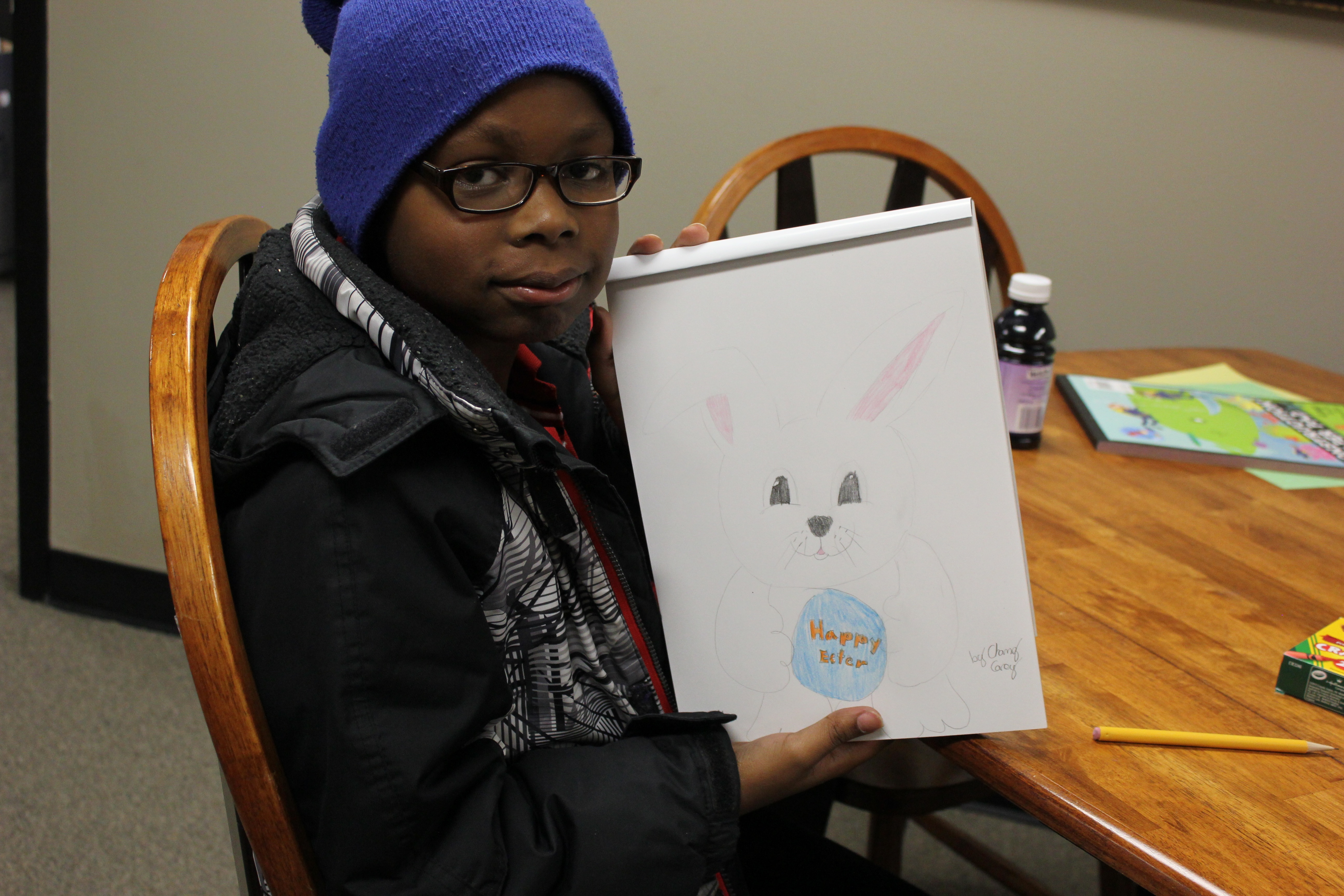 Chanz shows his drawing of the Easter bunny. 