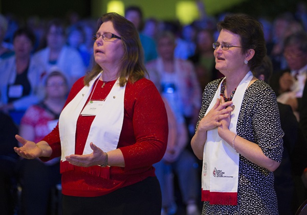 fea_1634_3181_beckyandjudypoole United Methodist Deaconesses Becky Louter (right) and Judy Poole sing during closing worship at the United Methodist Women's Assembly in 2014. Photo by Mike DuBose, UMNS.