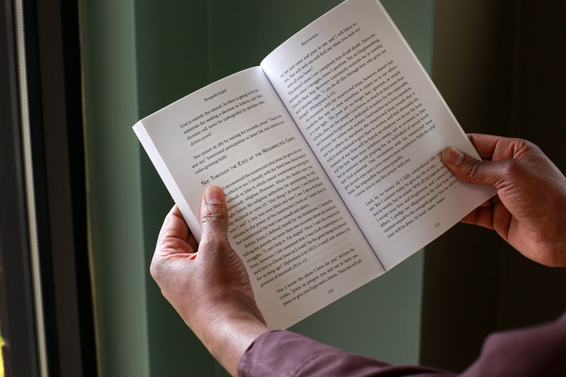 A man reads from Lenten study guide. Photo illustration by Kathleen Barry, United Methodist Communications.
