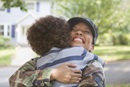 Excited returning soldier hugging her son. Photo by Blend Images - Kidstock / gettyimages.com
