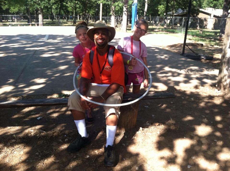 Who's teaching who to hula hoop? Roles sometimes reverse in fun ways at New Day Camp.