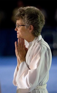 Bishop Peggy Johnson prays during opening worship at the 2012 United Methodist General Conference in Tampa, Florida. 