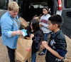 Debbie Humphrey, a United Methodist deaconess, delivers bags of supplementary food to poor children in an isolated community in Oklahoma. Photo by Paul Jeffrey, United Methodist Women.