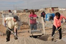 Mission team members from Suncreek United Methodist Church sift out rocks as part of the mortar-making process. They spent three days building a cinder-block home for the Quinoñes family of Ciudad Juárez, Mexico. Photo by Sam Hodges, UMNS.