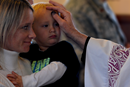 A child receives ashes on the forehead during an Ash Wednesday service at the Friendship Chapel at Shaw Air Force Base, S.C., Feb. 10, 2016. Ashes are applied to people’s foreheads to symbolize the dust from which God made humans. (U.S. Air Force photo by Senior Airman Michael Cossaboom).