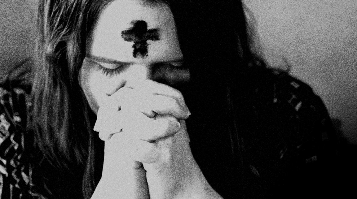 Love involves sacrifice and repentance. A woman prays after having ashes placed on her forehead during an Ash Wednesday service. Image by Kathleen Barry, United Methodist Communications.