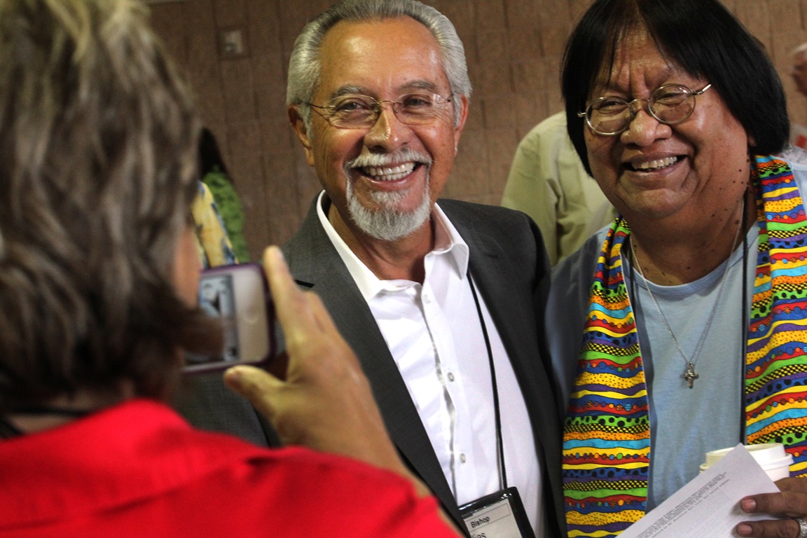 Bishop Elías Galván from Scottsdale, Az. and Tweedy Sombrero from Trinity United Methodist Church in Yuma, Az. are photographed by Anne Marshall from the Connectional Table using a cell phone. Photo by Kathleen Barry, UMNS.