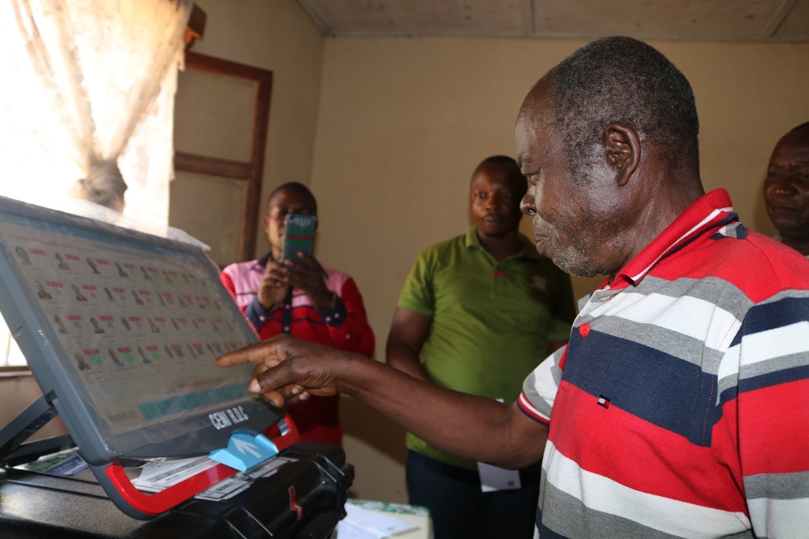 The Rev. Kanda Salumu examines an electronic voting machine during a demonstration in Kindu, Congo. The United Methodist Church is helping educate pastors and laypeople about the machines, which are unfamiliar to many Congolese. Photo by Chadrack Tambwe Londe, UMNS.
