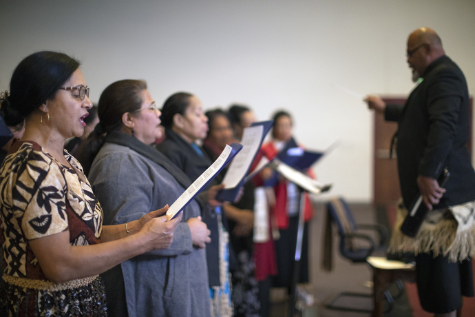Christiana Uesi (left) sings with others in the adult choir. Uesi is studying to be a certified lay minister and emphasizes that the future of the church is in bilingual services.