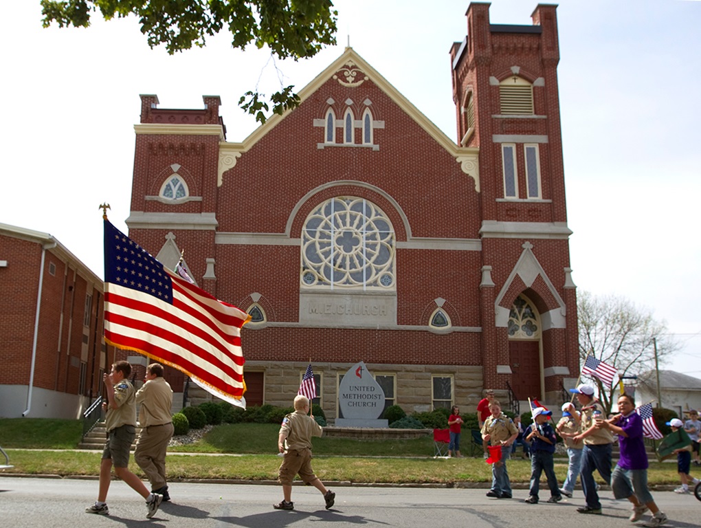 Boy Scouts from Troop 222 march in front of Leipsic (Ohio) United Methodist Church during the parade that kicks off the town's annual Fall Festival. Watching the parade, at left, is Luke Lammers. Photo by Mike DuBose, UMNS.