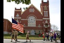 Boy Scouts from Troop 222 march in front of Leipsic (Ohio) United Methodist Church during the parade that kicks off the town's annual Fall Festival. Watching the parade, at left, is Luke Lammers. Photo by Mike DuBose, UMNS.