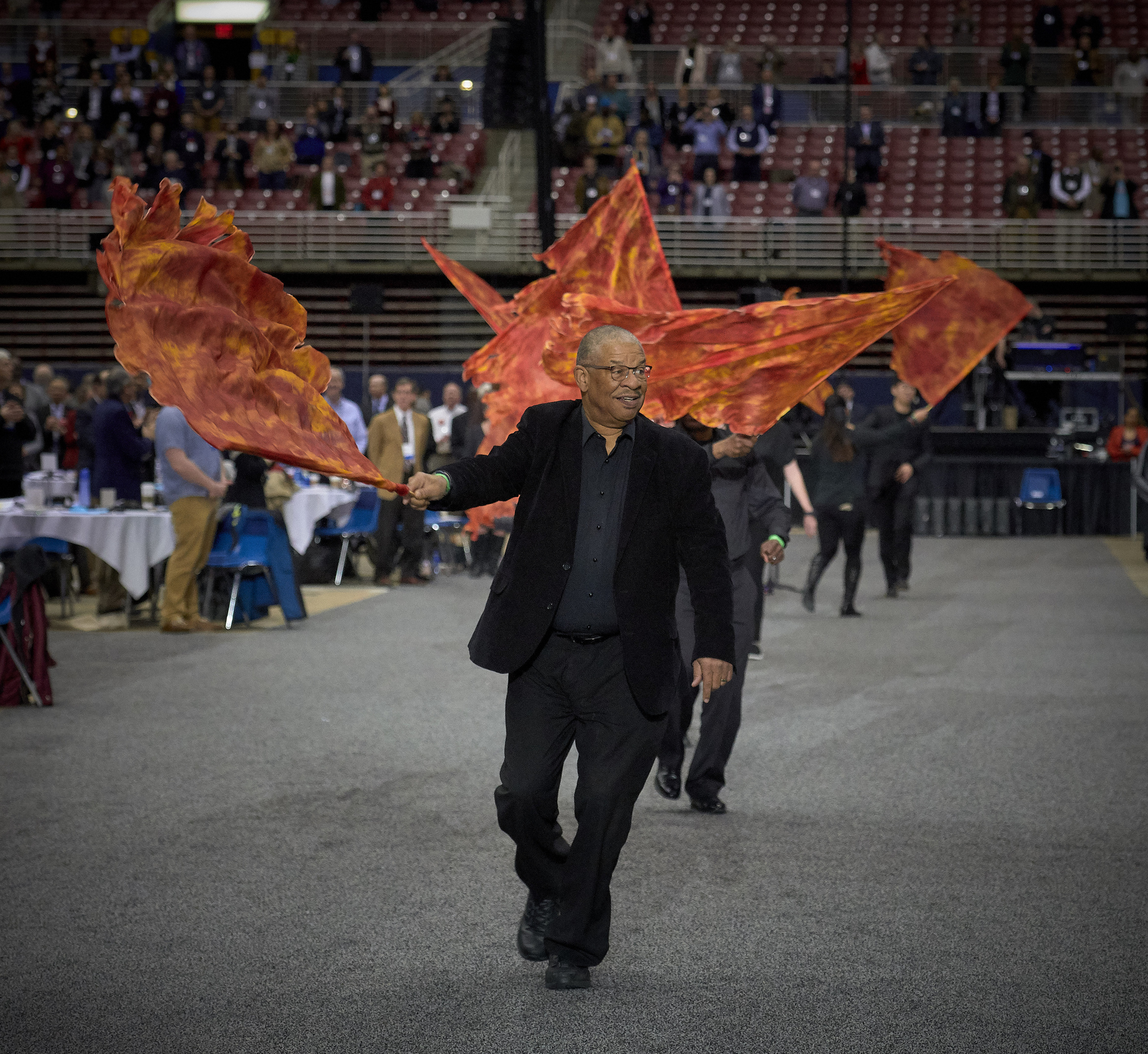 Tennessee Conference delegate Holly Neal (front) raises her arms in praise  during a day of prayer at the 2019 United Methodist General Conference in St. Louis. She is joined by Tennessee delegates the Revs. Stephen Handy (left) and Jacob Armstrong (standing). Photo by Mike DuBose, UMNS. 