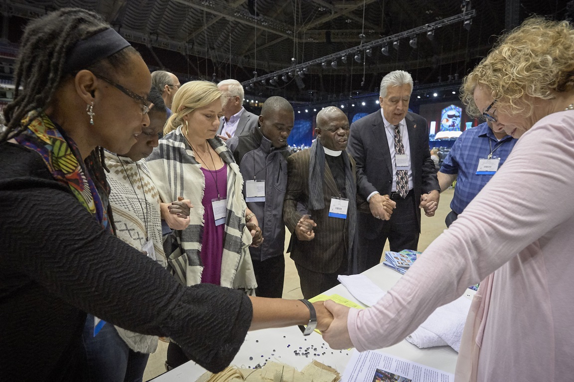 Delegates pray together during the February 23, 2019, opening session of the Special Session of the General Conference of The United Methodist Church. Photo by Paul Jeffrey for United Methodist News Service.