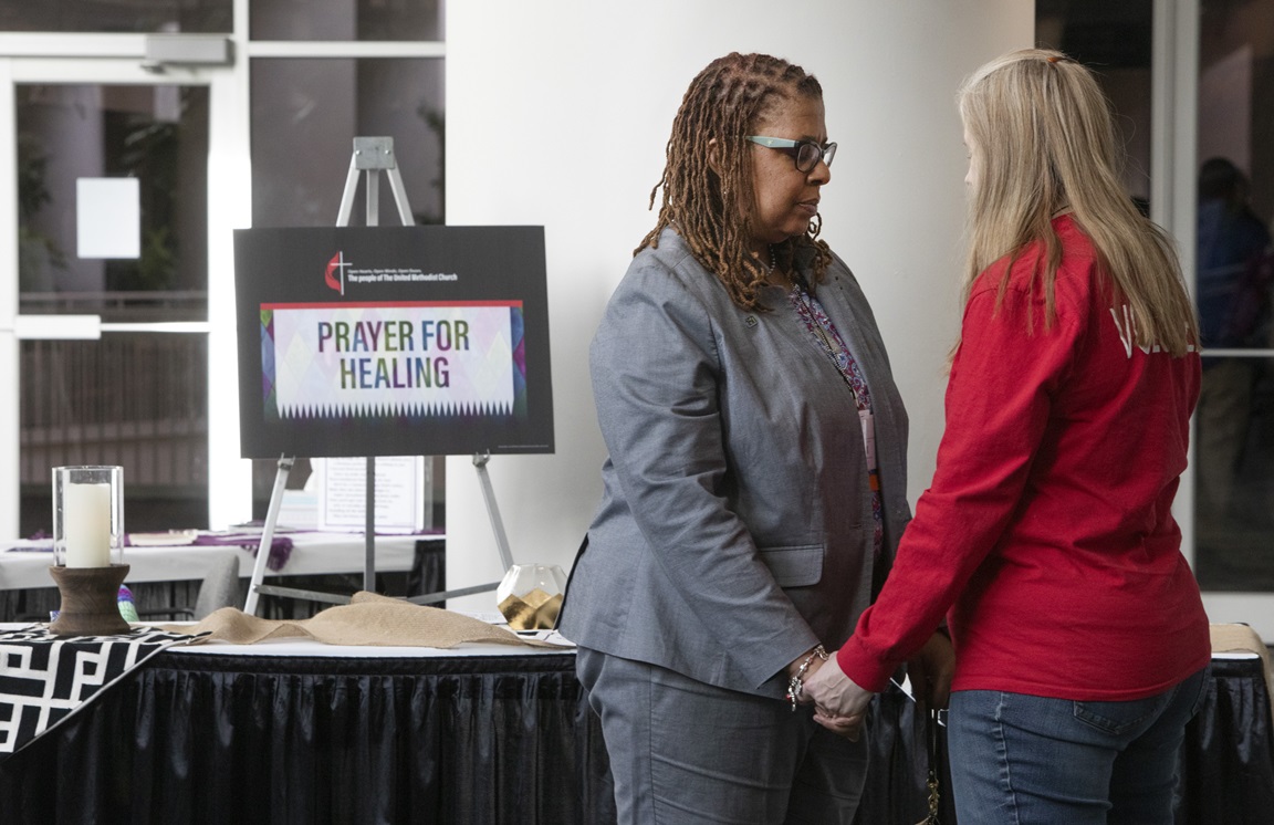 Scene from the prayer room of the 2019 General Conference in St. Louis. Praying together are Yvette Richards from the Missouri Conference and Jennifer Long, volunteer. Photo by Kathleen Barry, UMNS.