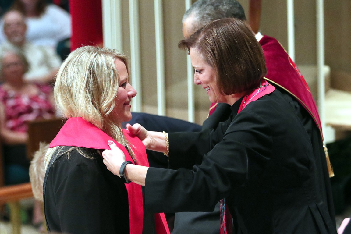 Tiffany Nagel Monroe (left) receives the stole of an elder from the Rev. Linda Harker during a service of ordination June 1, 2016, at St. Luke's United Methodist Church, in Oklahoma City. Photo by Hugh W. Scott, Oklahoma Conference.