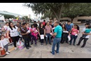 Eli Fernandez (front, in blue t-shirt), a volunteer with Catholic Charities, helps direct immigrants who have been released from detention by the U.S. Border Patrol and brought to the bus station in McAllen, Texas. Photo by Mike DuBose, UMNS.