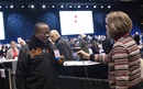 Marlene Fenstermacher, serving as a marshal at the 2019 special session of The United Methodist General Conference, scans in delegate Vargas Umba from North Katanga to the plenary floor. Photo by Kathleen Barry, UM News.