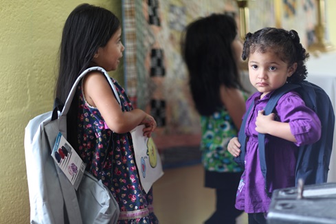 Cecilia Salamanca, left, and a young friend carry school backpacks. Photo by Kathleen Barry, UMNS