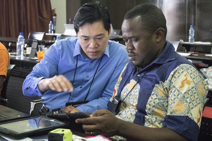 Danny Mai, chief technology officer with United Methodist Communications gives iPad instruction to Pierre Omadjela Tangomo during the Congo Central Conference communicator training held in Ndola, Zambia from Nov. 12-17, 2017. Photo by Kathleen Barry, UMNS.
