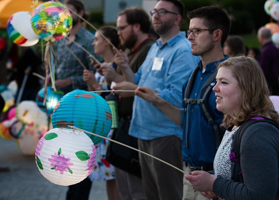 Katie Crise (right) holds a lantern lit by a solar powered lamp during the General Conference Climate Vigil at Oregon Convention Center Plaza in Portland. The vigil was held to call attention to climate change during the meeting of The United Methodist Church's top legislative body. Photo by Mike DuBose, UMNS.