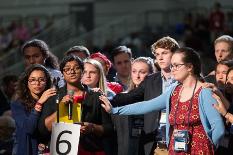 Ann Jacob of the Eastern Pennsylvania Conference is surrounded by other young people as she reads a statement on church unity adopted by the Global Young People's Convocation and Legislative Assembly. She presented the statement adopted in July 2015 during the afternoon plenary May 18 at the 2016 United Methodist General Conference in Portland, Ore. Photo by Mike DuBose, UMNS.