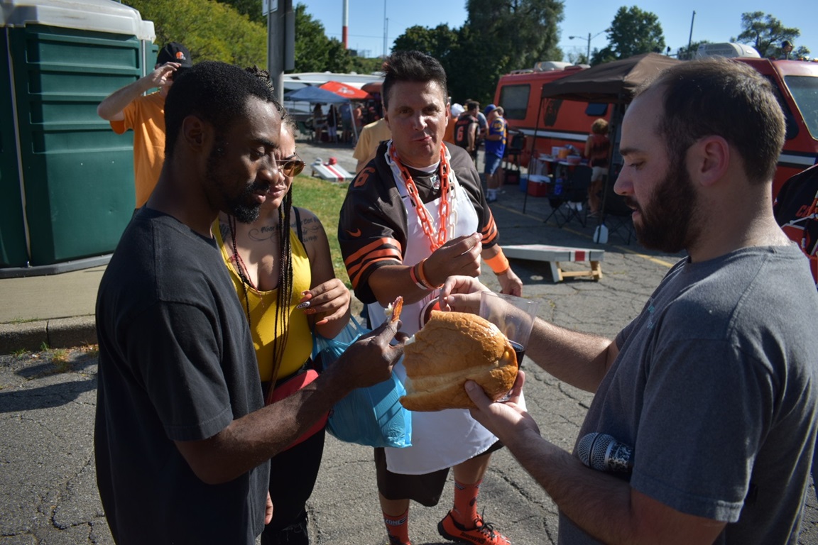 The Rev. Andrew Scott serving communion in Muni Lot before the Browns game. Photo courtesy of Shane Geisheimer. 2019