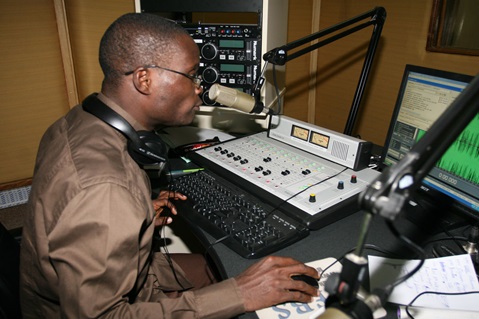 Joachim Gnatin Diahi monitors an afternoon broadcast at 101.6 FM Abidjan. Diahi is an anchor, producer and technician at the station.