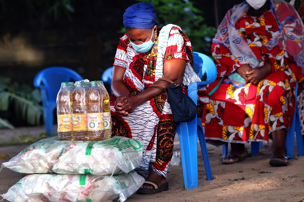 Akou Logbo bows her head as Bishop Benjamin Boni prays for the victims of flooding in Abidjan, Côte d’Ivoire, and the COVID-19 pandemic. She is one of 300 widows whose businesses were curtailed by the COVID-19-related lockdown. They received donations of food and non-food items worth $30,000 funded by the United Methodist Committee on Relief. Photo by Isaac Broune, UM News.