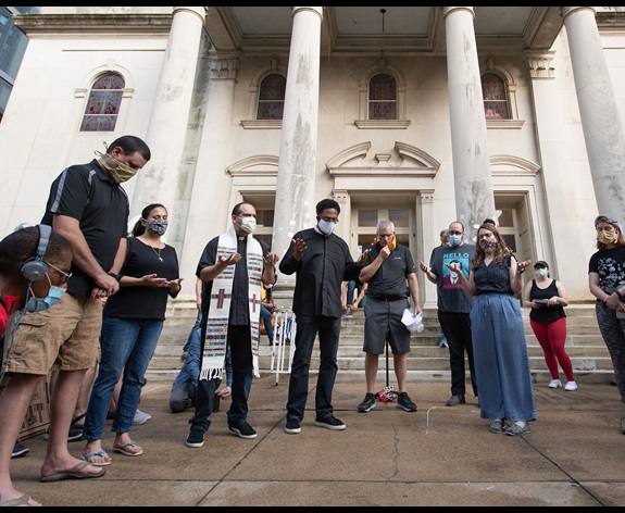 Clergy members gather in prayer during a vigil at McKendree United Methodist Church in Nashville, Tenn., to grieve and remember people lost to acts of racism. Photo by Mike DuBose, UM News.