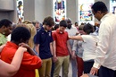 The Rev. Stephen Handy prays with the staff of the YouthWorks mission camp at McKendree United Methodist Church in Nashville, Tenn. Photo courtesy of McKendree United Methodist Church.