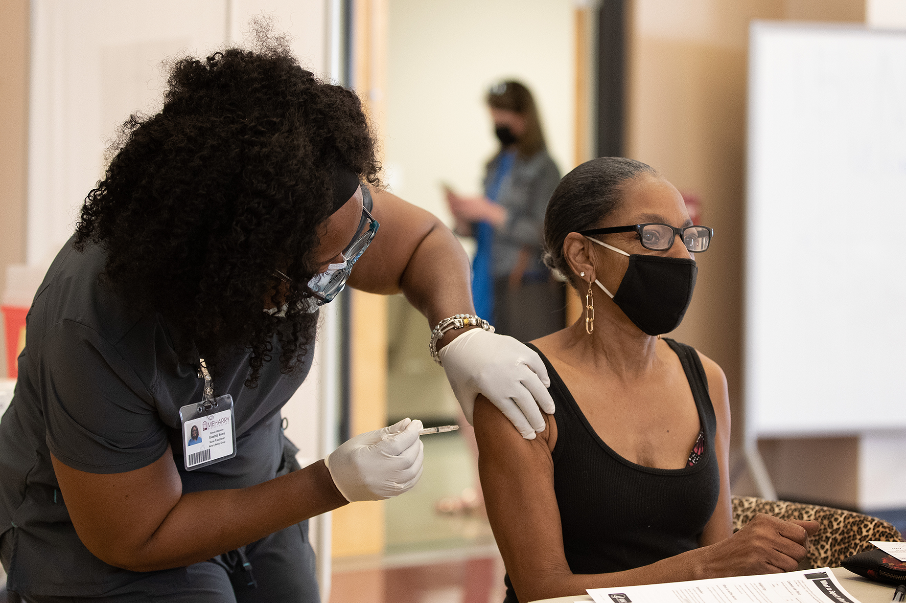 Joyce Holland receives a COVID-19 vaccination from Tia Moore, nurse practitioner, at Meharry Medical College in Nashville, Tenn. Photo by Mike DuBose UM News.
