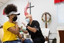 Ashlee Hand receives a COVID-19 vaccination from EMT Archie Coble during a clinic at St. Mark’s United Methodist Church in Charlotte, N.C. Photo by Mike DuBose, UM News.