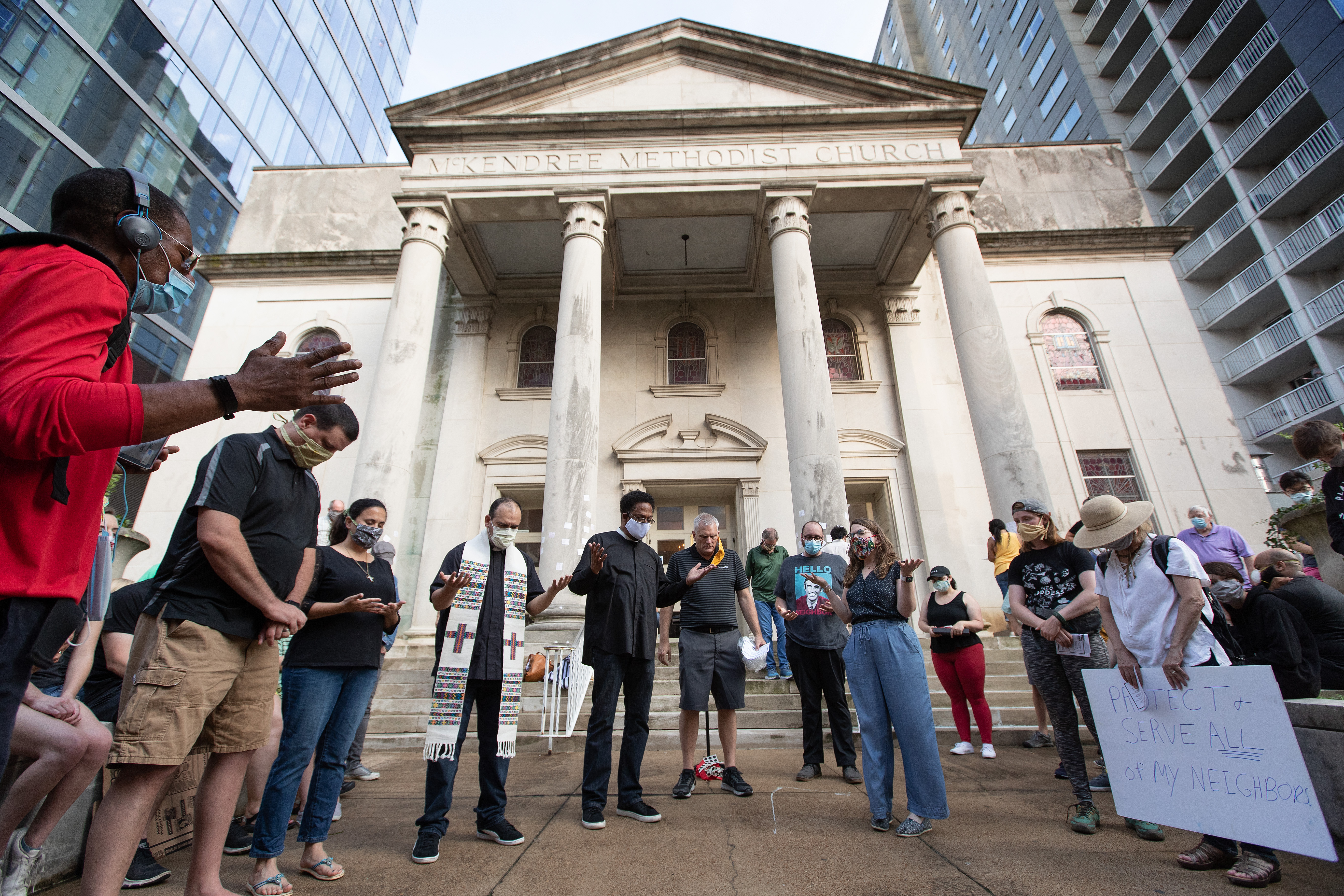 Clergy members gather in prayer during a vigil at McKendree United Methodist Church in Nashville, Tenn., to grieve and remember people lost to acts of racism. Photo by Mike DuBose, UM News.
