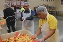 Joselito Javien Ortiz of the Philippines bags produce at the Oregon Food Bank as part of a volunteer effort during General Conference 2016.Video image by United Methodist Communications.