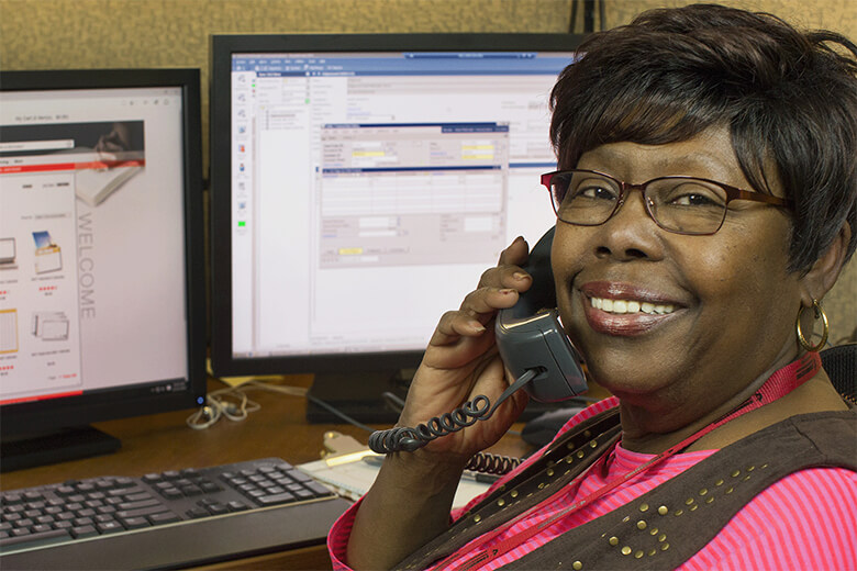 Audrey Ann Dowlen, retired customer service representative at United Methodist Communications, takes orders for United Methodist resources. File photo by Kathleen Barry, United Methodist Communications.