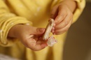 A child holds a hearing aid.
