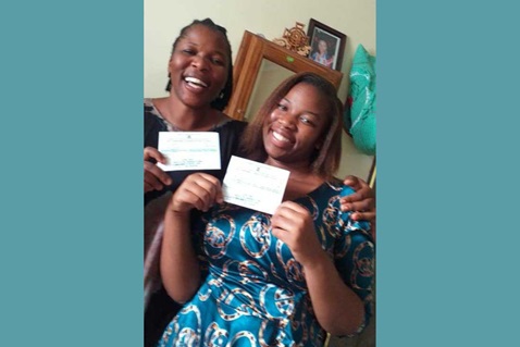 Anna Migera and her daughter Elizabeth Chacha show off their COVID-19 vaccination cards. (Photo courtesy of Anna Migera.)