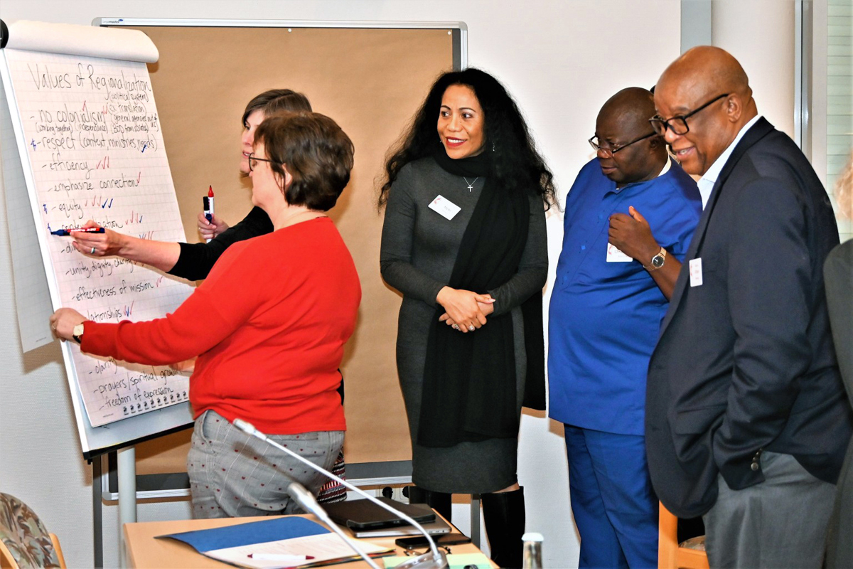 Members of the Standing Committee on Central Conference Matters discuss the values they are seeking in proposed denominational regionalization. During a meeting in Braunfels, Germany, the General Conference permanent committee gave a boost to proposals to restructure the denomination so different geographic areas are on equal footing. Photo by Klaus Ulrich Ruof, Germany Central Conference.  