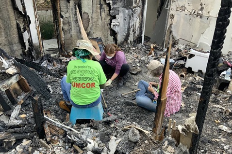 United Methodist Committee on Relief volunteer Helen Quirocho, Magnolia Becker and UMCOR’s Judy Lewis sift through wildfire wreckage in what is left of Becker’s home in the Truncas canyon of Malibu, California, on April 6, 2019. Photo by Doug Lewis.