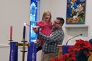 Ray Hausler, a lay supply preacher and part-time pastor, and his daughter Sophia light an Advent candle during the Dec. 10 worship service of the newly formed Haywood Emerging Faith Community, which meets at Clyde Central United Methodist Church in North Carolina. Even amid the grief of church disaffiliations, new United Methodist faith communities are springing up across the U.S. Hausler was part of a remnant group that formed the new United Methodist faith community after their congregation voted to disaffiliate. Photo courtesy of Haywood Emerging Faith Community.