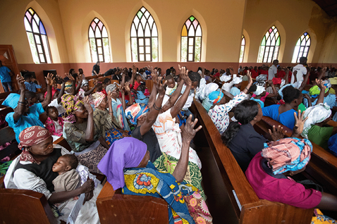 Members of the congregation raise their hands in praise at the Central United Methodist Church of Quéssua, Angola. Photo by Mike DuBose, UM News.