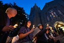 On the eve of the 2024 United Methodist General Conference in Charlotte, N.C., climate activists hold a candlelight Vigil for Creation to mark Earth Day and to call the denomination to greater stewardship of creation. Participants included Thomas Elliott (left), a professor at the Candler School of Theology in Atlanta, and Candler students Mary Frances Gaston (center) and Emily McGinn. The service took place at the First United Methodist Church of Charlotte. Photo by Mike DuBose, UM News.