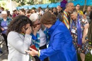 Bishop Karen Oliveto (in blue jacket) and her wife, Robin Ridenour (front, center) join in embracing delegates and visitors to the United Methodist General Conference in Charlotte, N.C., after the conference voted to remove the denomination’s longtime ban on the ordination of clergy who are “self-avowed practicing homosexuals.” Photo by Mike DuBose, UM News.