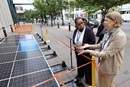 The Rev. Jenny Phillips (right) shows a Mobile Solar Power Station to Bishop Robin Dease outside the United Methodist General Conference in Charlotte, N.C. Phillips is the director of environmental sustainability with the United Methodist Board of Global Ministries. Photo by Mike DuBose, UM News.