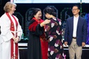 Bishop Sue Haupert-Johnson (left), the Rev. Judy Chung and Jay Choy (right) commission Sora Lee as a Missionary in a ceremony during the United Methodist General Conference in Charlotte, N.C. Photo by Mike DuBose, UM News.