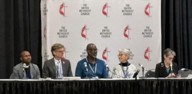 (L-R) Rev. Ande Emmanuel, John Hill, Dr. Randall Miller, Dr. Mary Elizabeth Moore, and Bishop Sally Dyck host press briefing at General Conference, Charlotte after historic Revised Social Principles adoption. Photo courtesy of Church and Society.