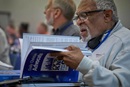 Ivan James, a lay delegate from the Missouri Conference, reviews the collection of legislation that he and other committee members are considering in the first days of the 2024 United Methodist General Conference in Charlotte, N.C. Photo by Paul Jeffrey, UM News.