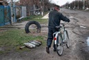 The village of Andriivka was occupied by Russian forces for 35 days. The main road linking Bodoroyanka to Markeridge runs through it, and a man on a bike passes by active warheads out in the open. (Photo: Sean Sutton, MAG.)
