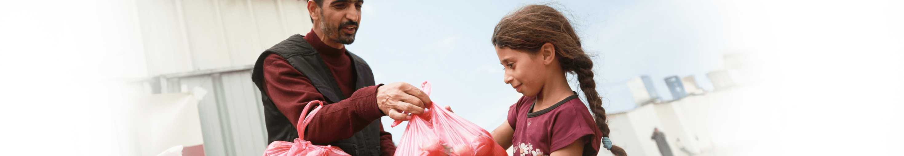 UMC Giving, UMCor Sunday, Man handing, vegetables, young girl